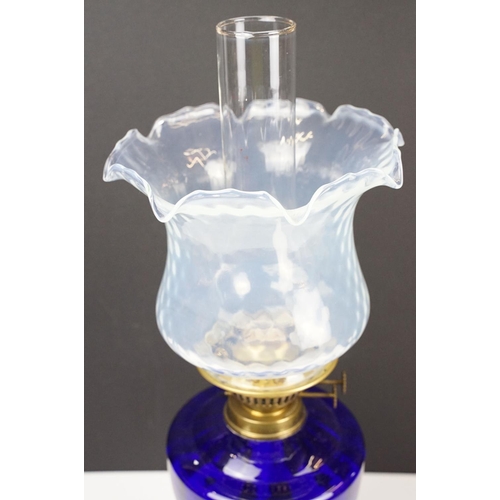 135 - Early-to-mid 20th C oil lamp with opalescent flared glass shade, chimney, cobalt blue glass font and... 