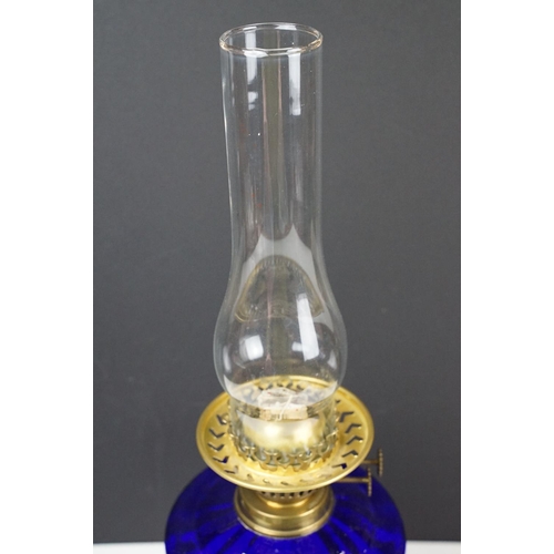 135 - Early-to-mid 20th C oil lamp with opalescent flared glass shade, chimney, cobalt blue glass font and... 