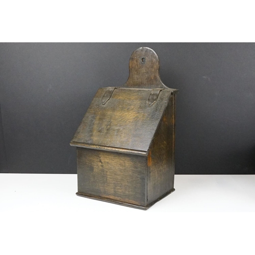 159 - Antique oak Welsh wall mounting salt box with hinge lid and wall bracket. Measures 41cm tall.