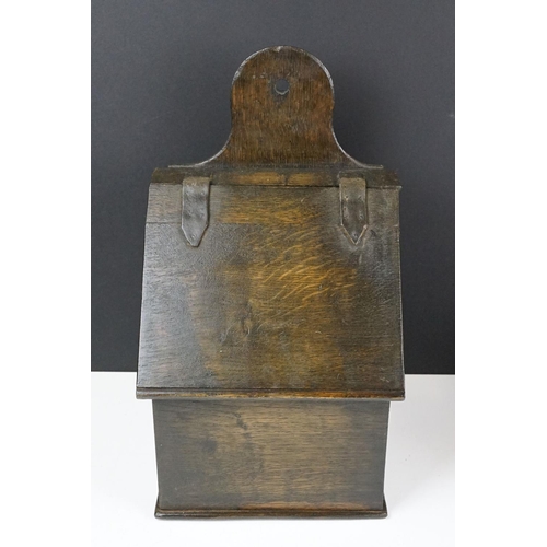 159 - Antique oak Welsh wall mounting salt box with hinge lid and wall bracket. Measures 41cm tall.