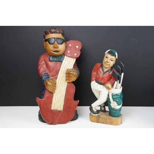 161 - Two carved wooden figures to include a double bass band player and golfer. Tallest measures 41cm tal... 