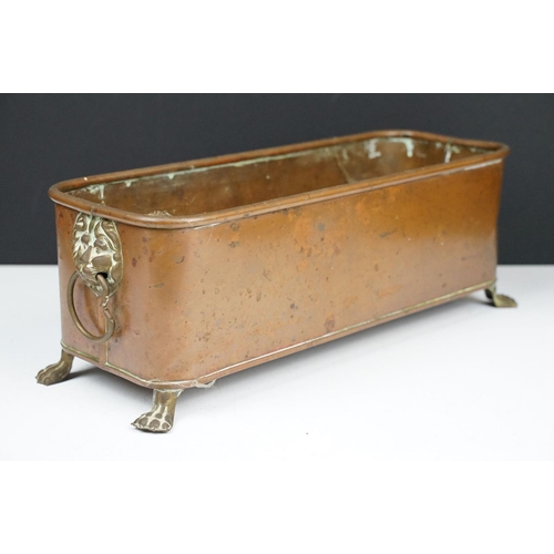 177 - Copper planter of rectangular form with rounded corners and rolled edge, having a pair of lion mask ... 