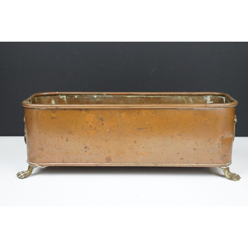 177 - Copper planter of rectangular form with rounded corners and rolled edge, having a pair of lion mask ... 