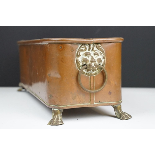 177 - Copper planter of rectangular form with rounded corners and rolled edge, having a pair of lion mask ... 