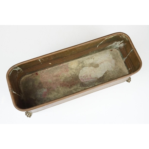 177 - Copper planter of rectangular form with rounded corners and rolled edge, having a pair of lion mask ... 