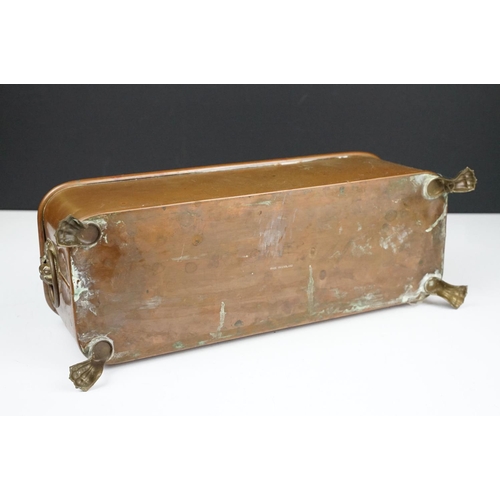 177 - Copper planter of rectangular form with rounded corners and rolled edge, having a pair of lion mask ... 