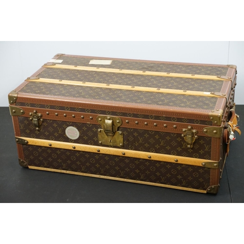 266 - Louis Vuitton - Monogrammed canvas travel trunk having branded leather banding, wooden slats, brass ... 