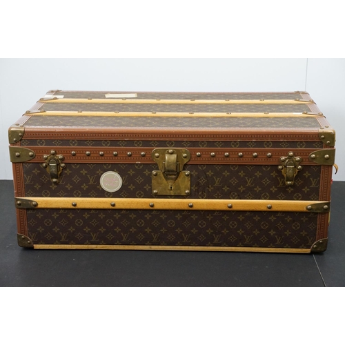 266 - Louis Vuitton - Monogrammed canvas travel trunk having branded leather banding, wooden slats, brass ... 