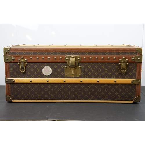 266 - Louis Vuitton - Monogrammed canvas travel trunk having branded leather banding, wooden slats, brass ... 