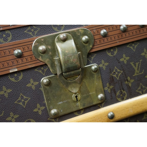 266 - Louis Vuitton - Monogrammed canvas travel trunk having branded leather banding, wooden slats, brass ... 