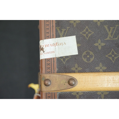 266 - Louis Vuitton - Monogrammed canvas travel trunk having branded leather banding, wooden slats, brass ... 