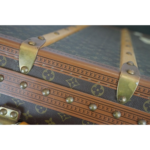 266 - Louis Vuitton - Monogrammed canvas travel trunk having branded leather banding, wooden slats, brass ... 