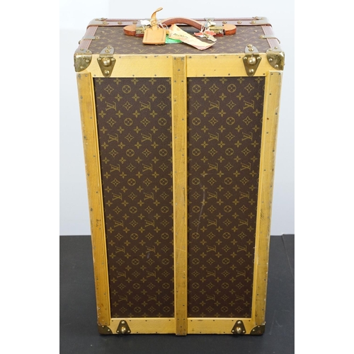 266 - Louis Vuitton - Monogrammed canvas travel trunk having branded leather banding, wooden slats, brass ... 