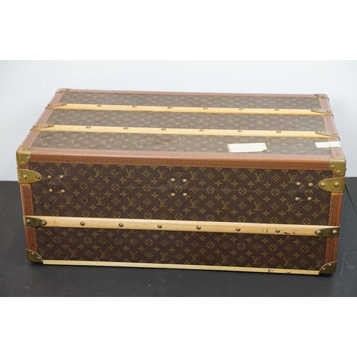 266 - Louis Vuitton - Monogrammed canvas travel trunk having branded leather banding, wooden slats, brass ... 