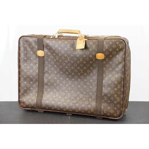 267 - Louis Vuitton - Satellite suitcase having a monogrammed body with two canvas straps and brown leathe... 