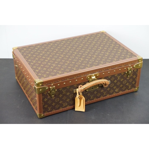 268 - Louis Vuitton - Monogrammed canvas trunk with brass fittings and lock, opening to reveal beige inter... 