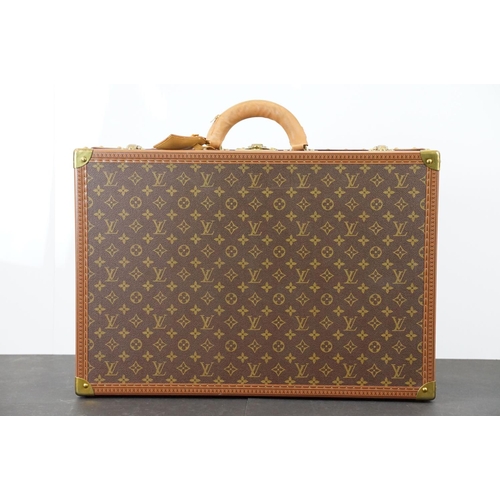 268 - Louis Vuitton - Monogrammed canvas trunk with brass fittings and lock, opening to reveal beige inter... 