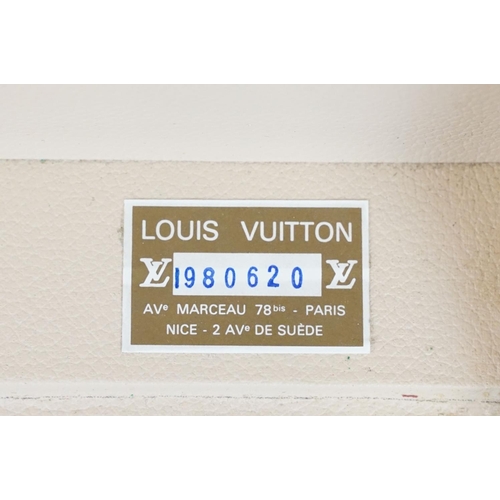 268 - Louis Vuitton - Monogrammed canvas trunk with brass fittings and lock, opening to reveal beige inter... 