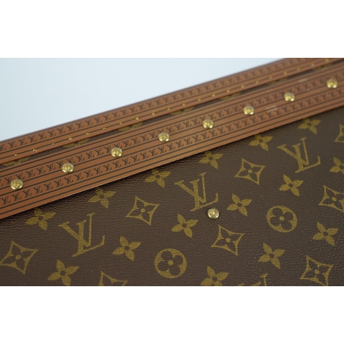 268 - Louis Vuitton - Monogrammed canvas trunk with brass fittings and lock, opening to reveal beige inter... 