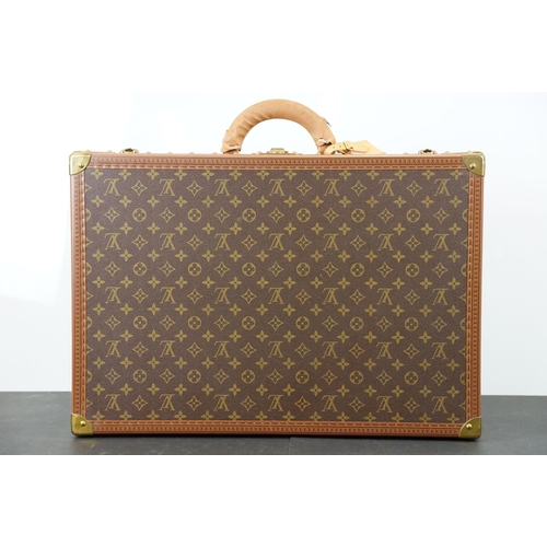 268 - Louis Vuitton - Monogrammed canvas trunk with brass fittings and lock, opening to reveal beige inter... 