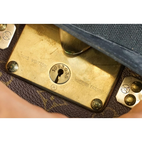 268 - Louis Vuitton - Monogrammed canvas trunk with brass fittings and lock, opening to reveal beige inter... 