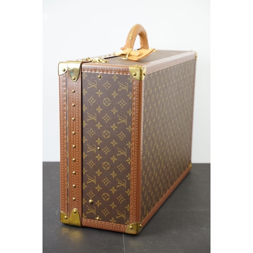 268 - Louis Vuitton - Monogrammed canvas trunk with brass fittings and lock, opening to reveal beige inter... 