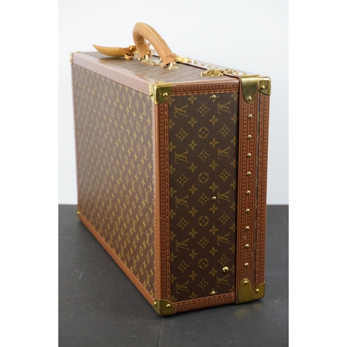 268 - Louis Vuitton - Monogrammed canvas trunk with brass fittings and lock, opening to reveal beige inter... 