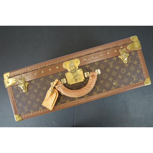 268 - Louis Vuitton - Monogrammed canvas trunk with brass fittings and lock, opening to reveal beige inter... 