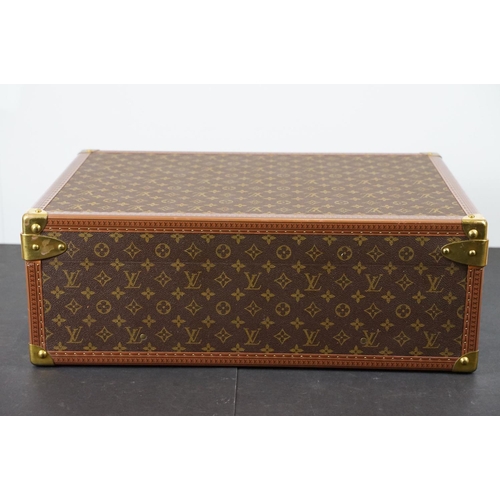 268 - Louis Vuitton - Monogrammed canvas trunk with brass fittings and lock, opening to reveal beige inter... 