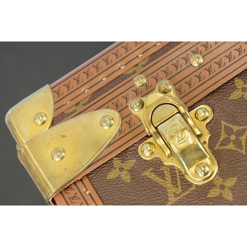 268 - Louis Vuitton - Monogrammed canvas trunk with brass fittings and lock, opening to reveal beige inter... 