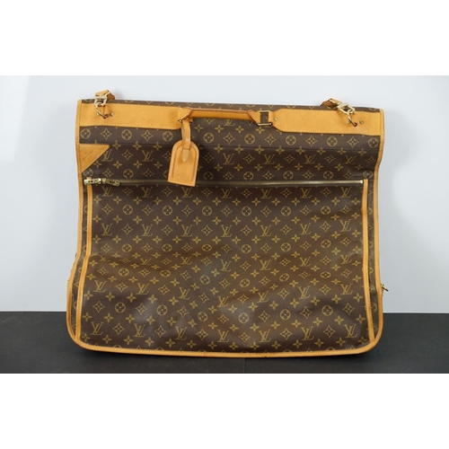 269 - Louis Vuitton - Garment bag having a monogrammed body with tanned leather handles and woven shoulder... 