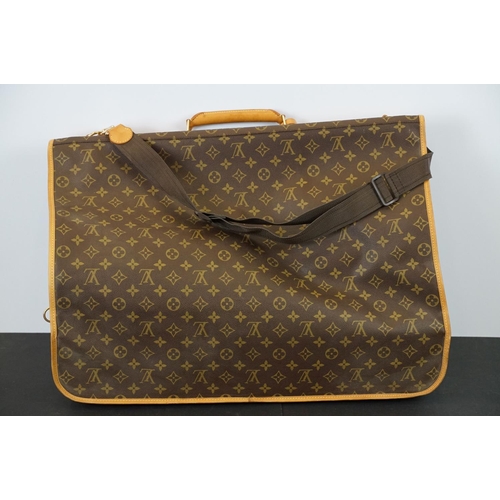 269 - Louis Vuitton - Garment bag having a monogrammed body with tanned leather handles and woven shoulder... 