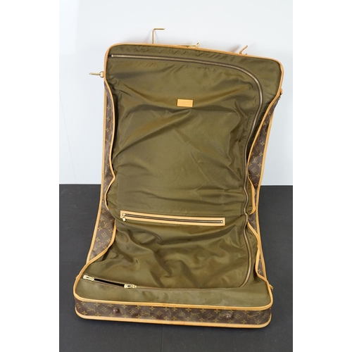 269 - Louis Vuitton - Garment bag having a monogrammed body with tanned leather handles and woven shoulder... 