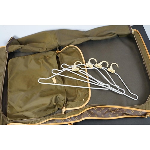 269 - Louis Vuitton - Garment bag having a monogrammed body with tanned leather handles and woven shoulder... 