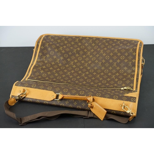 269 - Louis Vuitton - Garment bag having a monogrammed body with tanned leather handles and woven shoulder... 