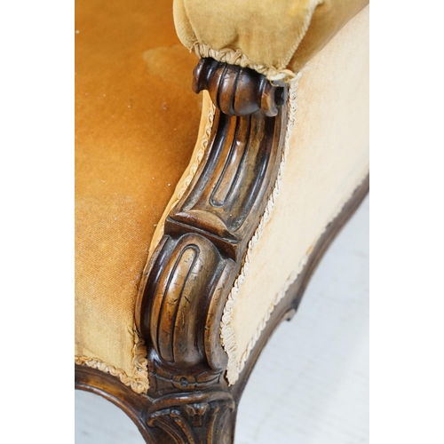 654 - Early 20th century wing back armchair of curved form, with button back, upholstered in orange, on tu... 