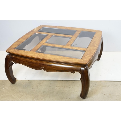 655 - Walnut coffee table, in the Oriental style, with five bevelled glass panels, 44cm high x 96.5cm wide... 