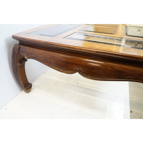 655 - Walnut coffee table, in the Oriental style, with five bevelled glass panels, 44cm high x 96.5cm wide... 