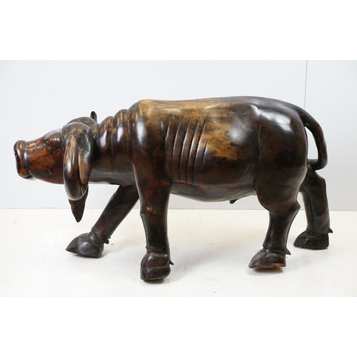 659 - Hardwood carved figure of a water buffalo, 57cm high x 109cm long x 33cm deep