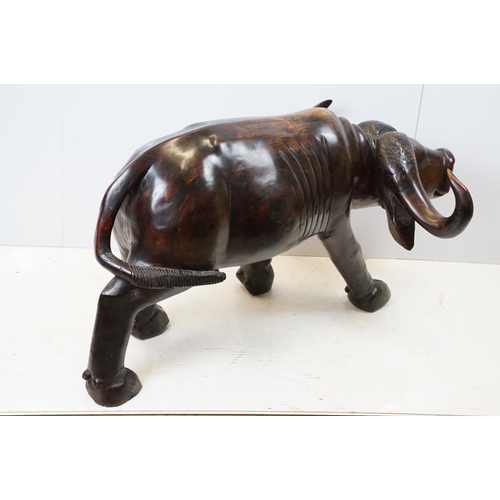 659 - Hardwood carved figure of a water buffalo, 57cm high x 109cm long x 33cm deep