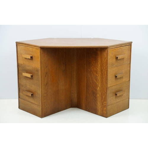 671 - 20th century oak kneehole desk, with a hexagonal top over an arrangement of six drawers, 62cm high x... 