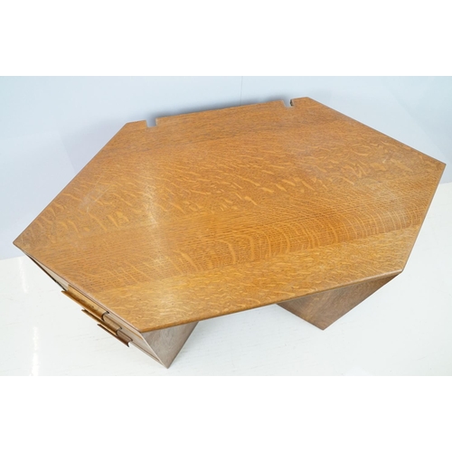 671 - 20th century oak kneehole desk, with a hexagonal top over an arrangement of six drawers, 62cm high x... 