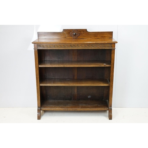 684 - Oak three shelf bookcase with Greek key frieze design, 102cm high x 92cm wide x 26cm deep