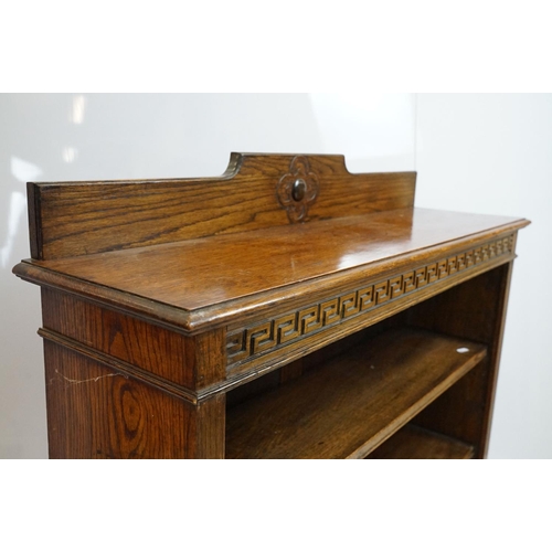 684 - Oak three shelf bookcase with Greek key frieze design, 102cm high x 92cm wide x 26cm deep