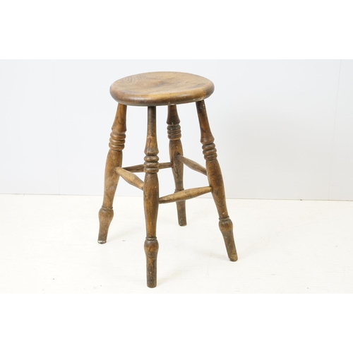 689 - 19th century Elm Circular Stool raised on turned ringed legs, 36cm wide x 55cm high