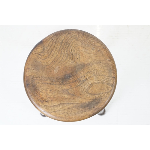 689 - 19th century Elm Circular Stool raised on turned ringed legs, 36cm wide x 55cm high