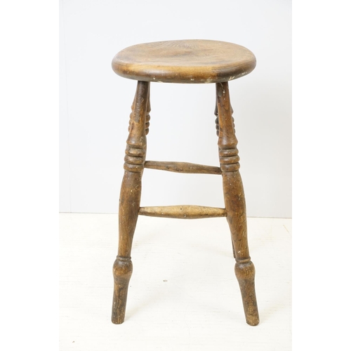 689 - 19th century Elm Circular Stool raised on turned ringed legs, 36cm wide x 55cm high