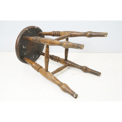 689 - 19th century Elm Circular Stool raised on turned ringed legs, 36cm wide x 55cm high
