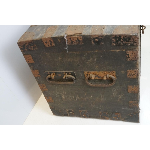 697 - Early 20th century oak and metal mounted travelling trunk, with two handles to each side, brass plaq... 