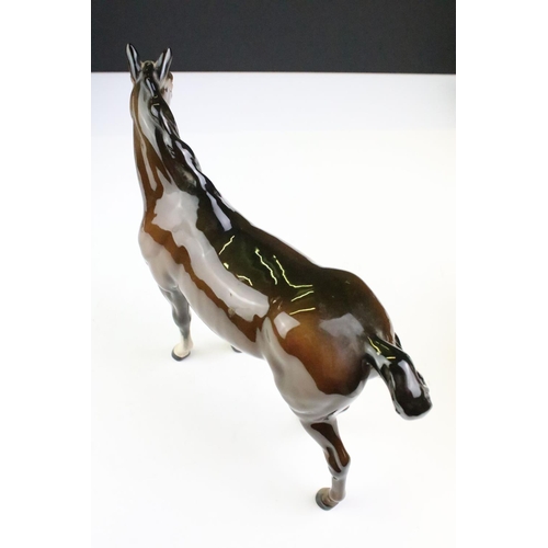 27 - Collection of seven Beswick porcelain horses / ponies to include six brown gloss examples and a matt... 